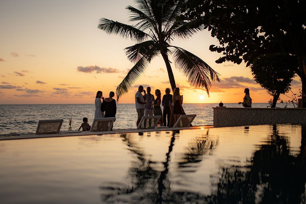 Celebrate with friends and family Group at oceanfront pool at sunset