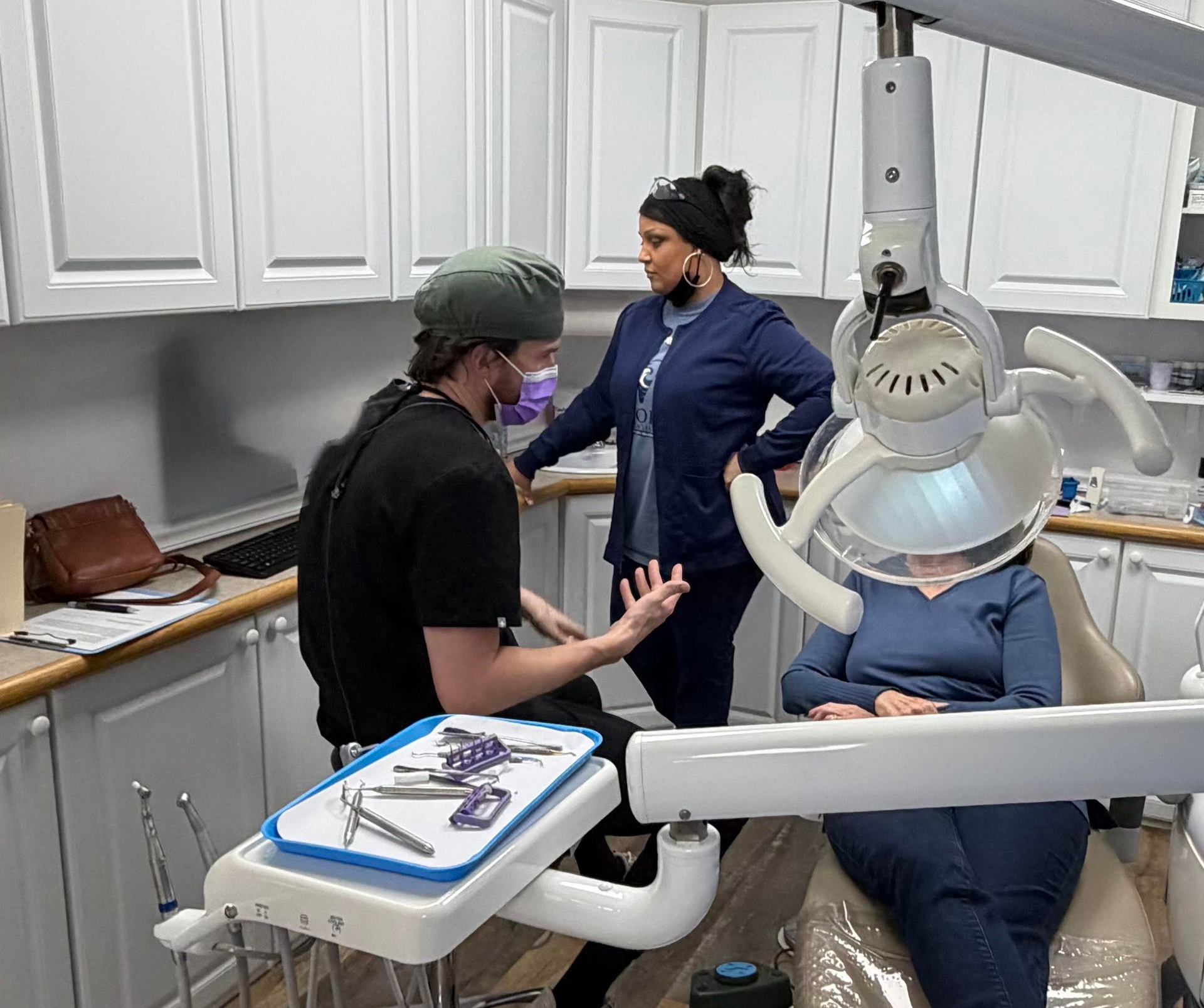 Docks filled with boats at sunrise, orange and purple sky over water.