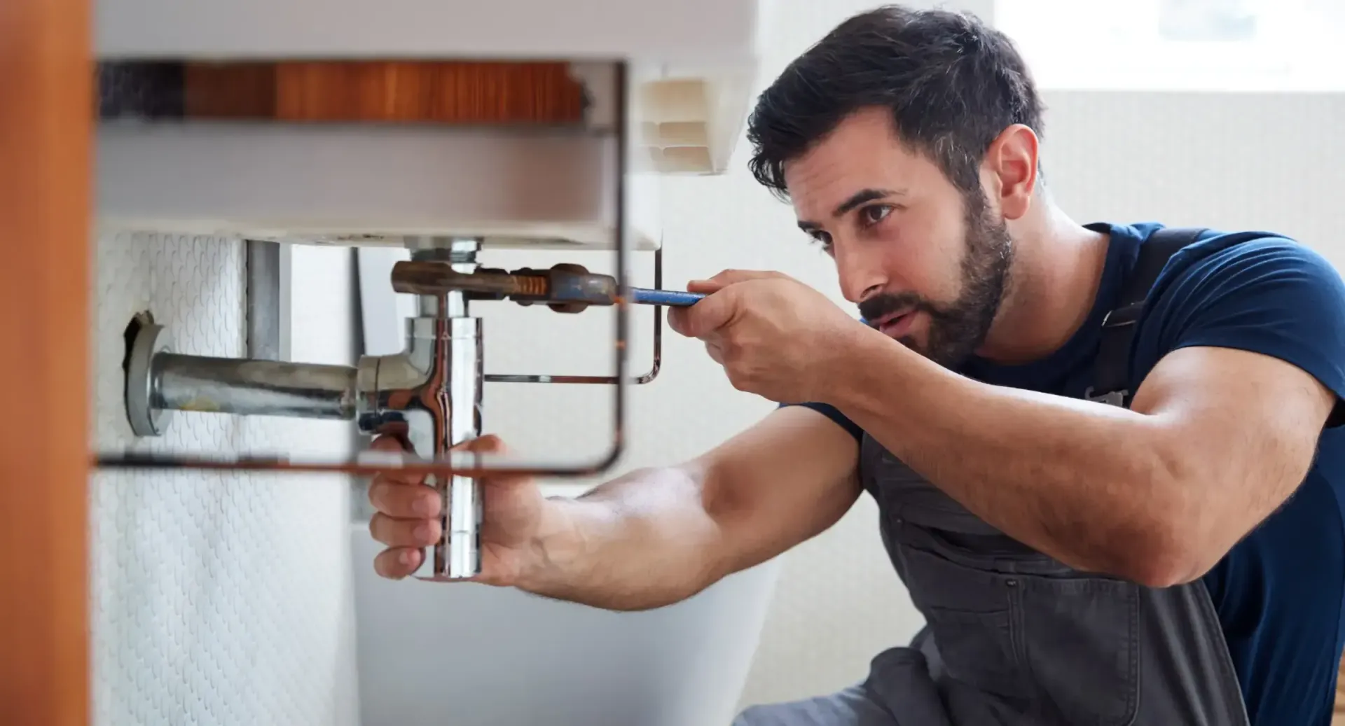 MasterCraft Plumbing plumber working on a sink and pipes