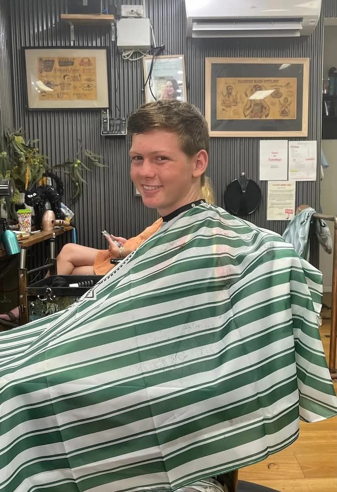 Boy Sitting on Barber Chair Ready for Haircut — Barbers in Darwin, NT