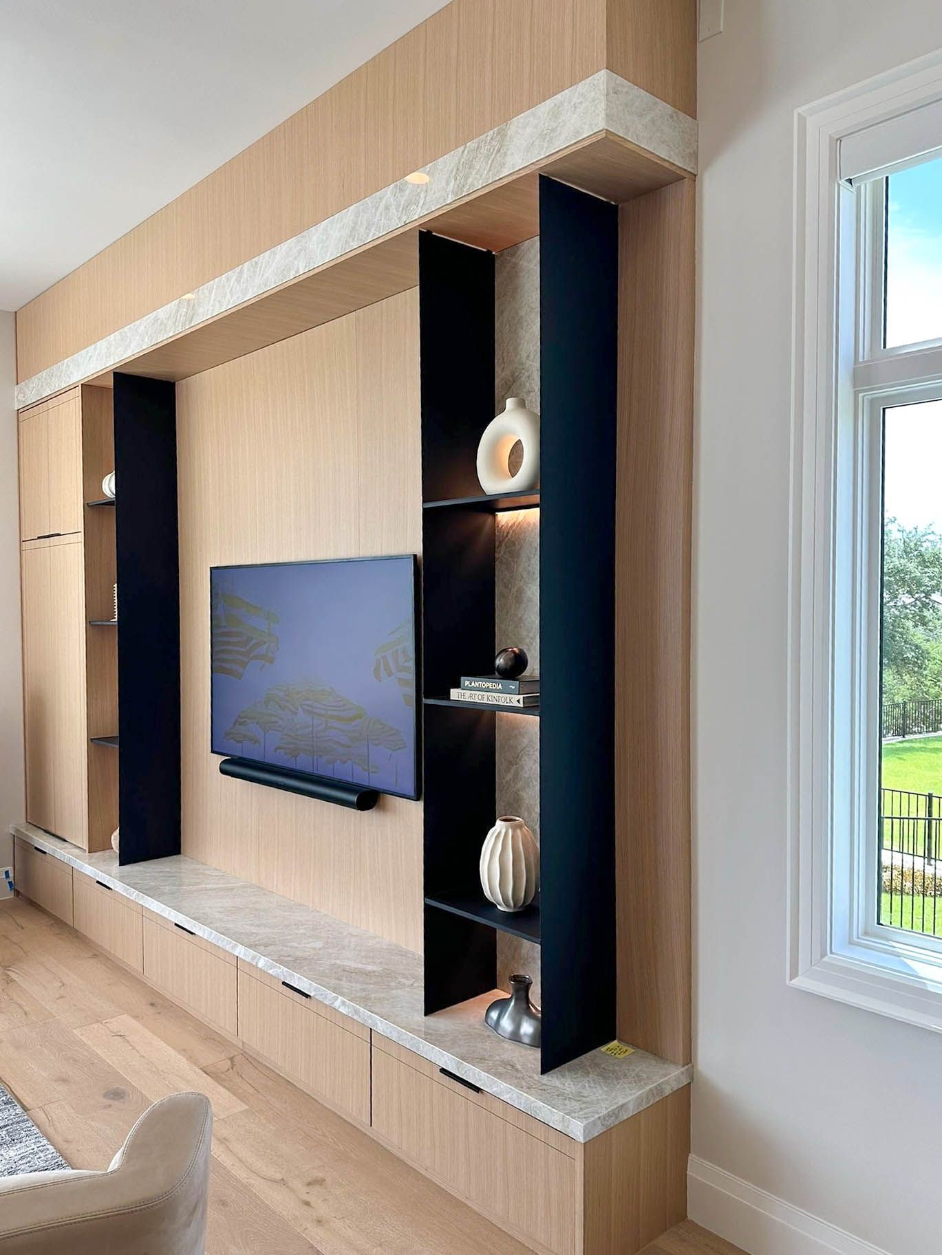 Modern building on stilts against a snowy landscape and blue sky.