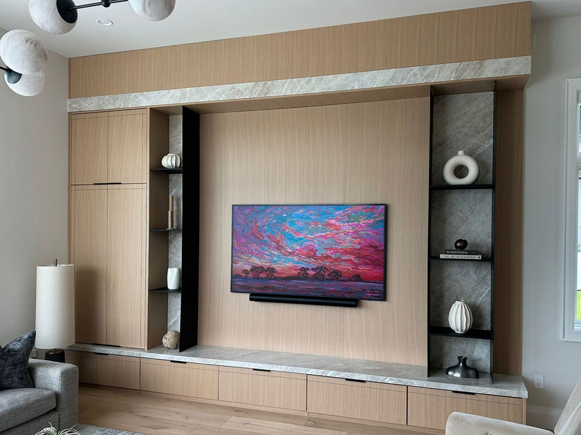 White kitchen with island, cabinets, stainless steel appliances, and hardwood floors.