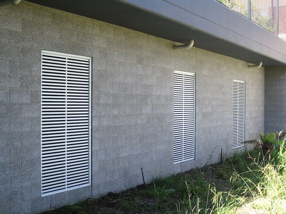 A Brick Building With White Privacy Screens — Hunter Valley Lattice in Kurri Kurri, NSW