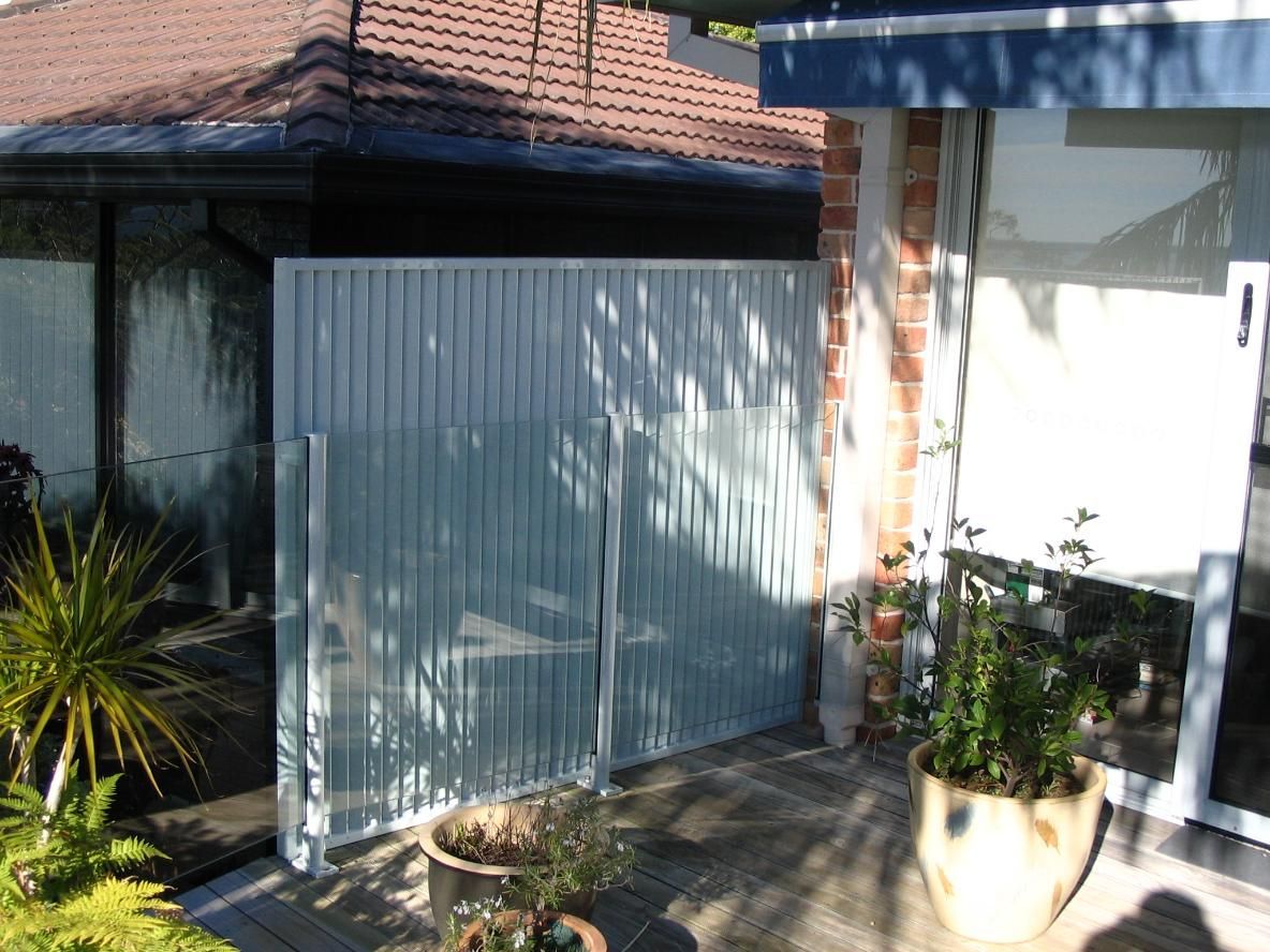 A House With a Fence and Potted Plants in Front of It — Hunter Valley Lattice in Cessnock, NSW