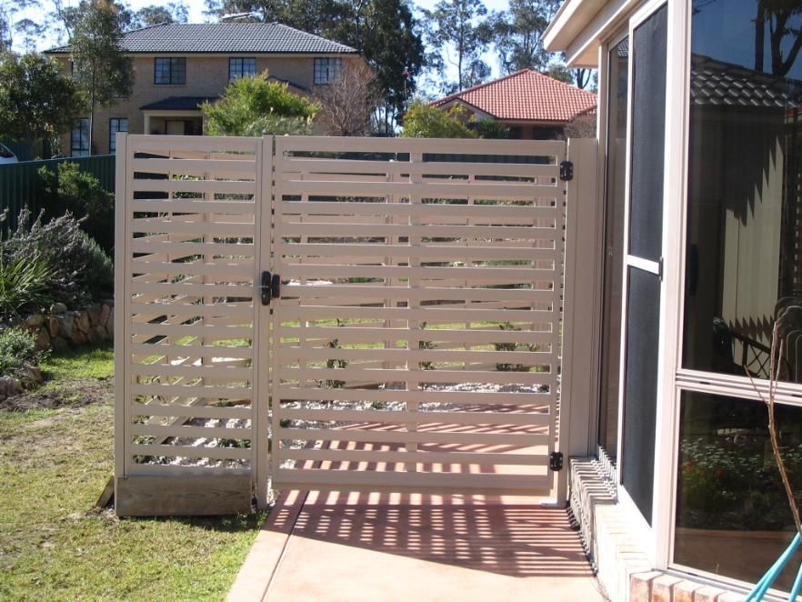 A Wooden Fence With a Gate in the Backyard — Hunter Valley Lattice in Lake Macquarie, NSW