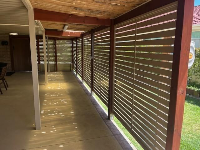 A Long Hallway With Wooden Shutters on the Side of It — Hunter Valley Lattice in Port Stephens, NSW