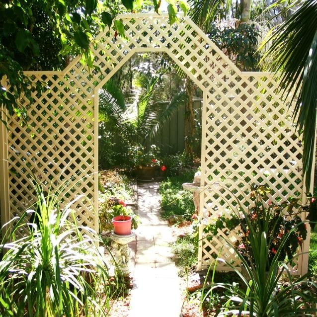 A Garden With a White Lattice Archway Leading to a Path — Hunter Valley Lattice in Lake Macquarie, NSW