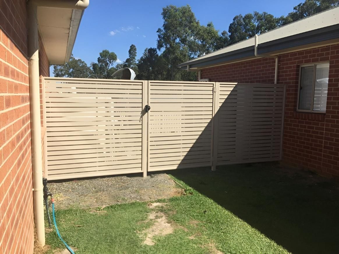 A White Fence is in the Backyard of a Brick House — Hunter Valley Lattice in Port Stephens, NSW