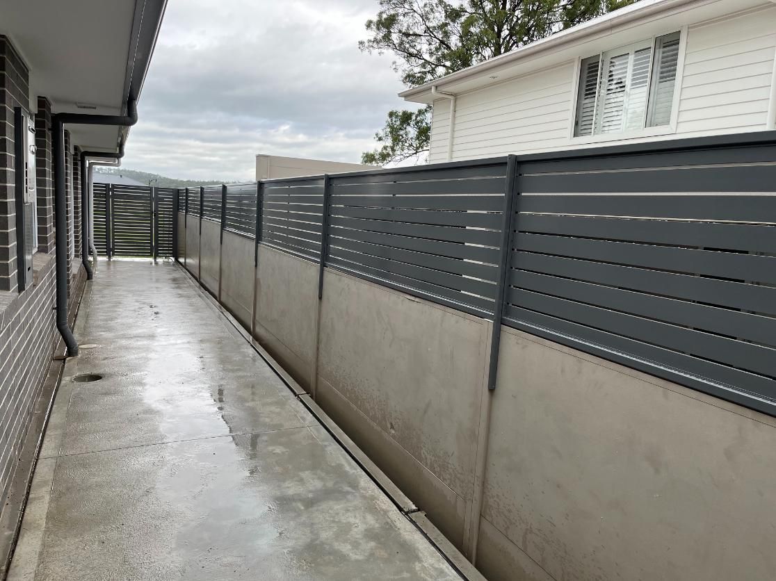 A Long Concrete Walkway With a Fence Between Two Houses — Hunter Valley Lattice in Lake Macquarie, NSW