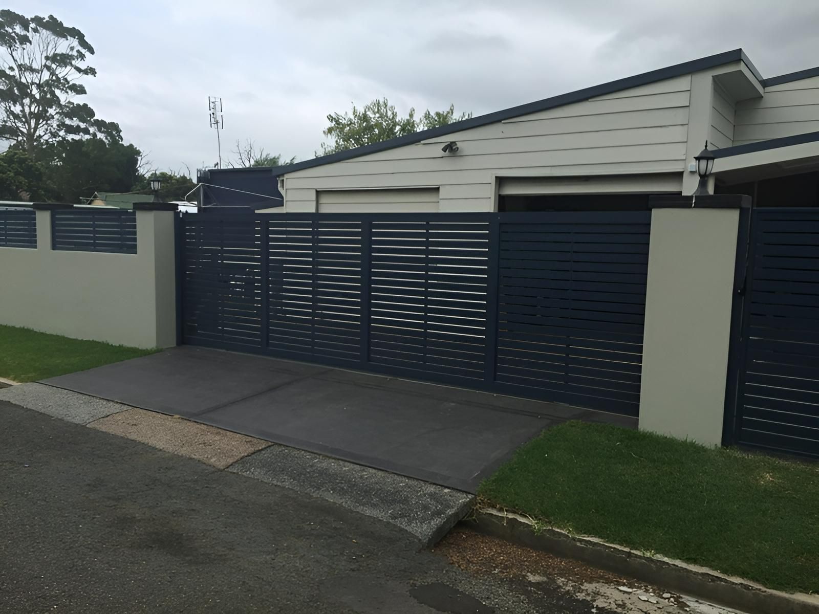 A House With a Blue Fence Surrounding It — Hunter Valley Lattice in Cessnock, NSW