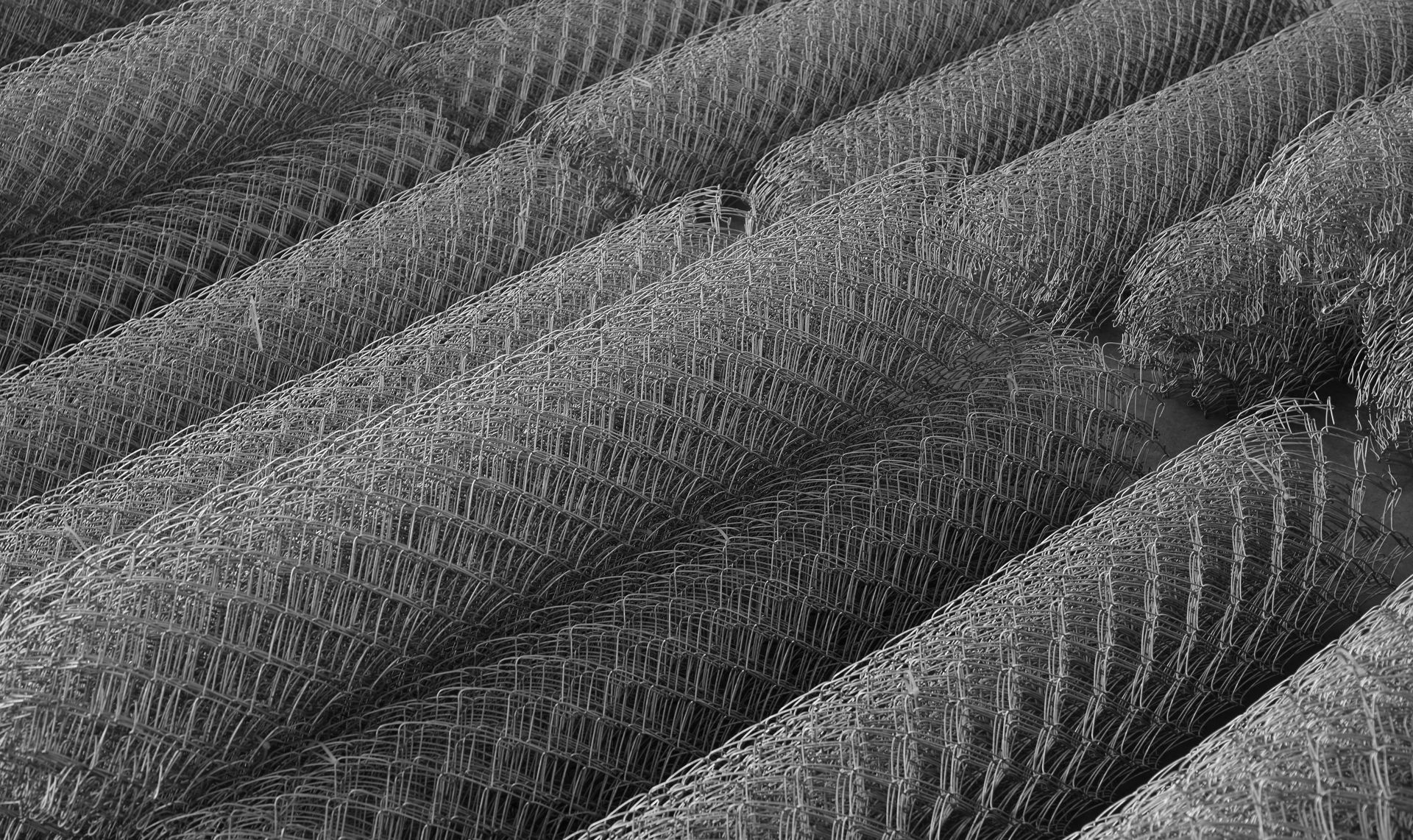 Mesh wire rolls of galvanised metal sheets.