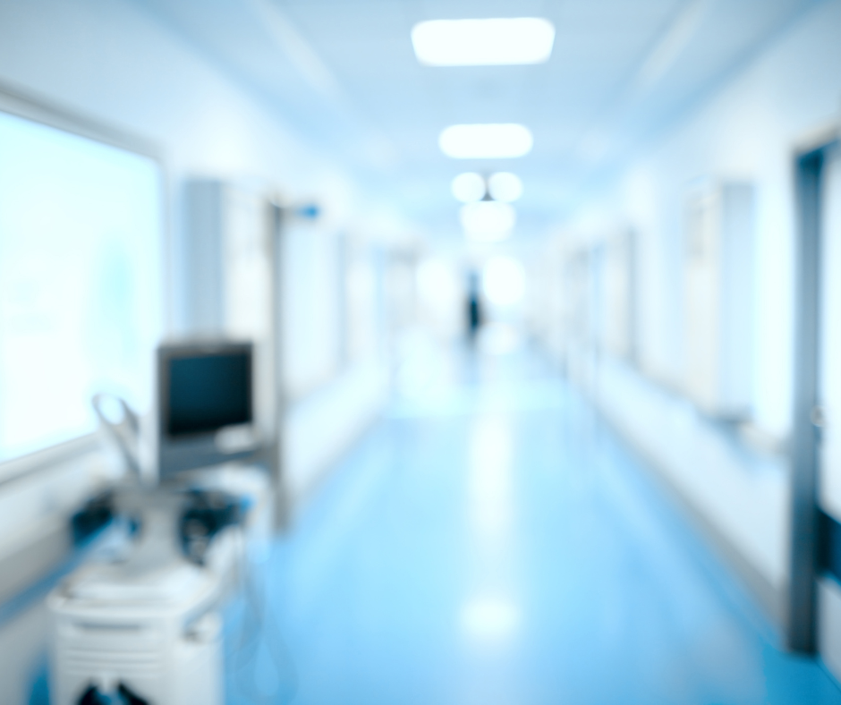 A picture of a hospital hallway with blue floors.