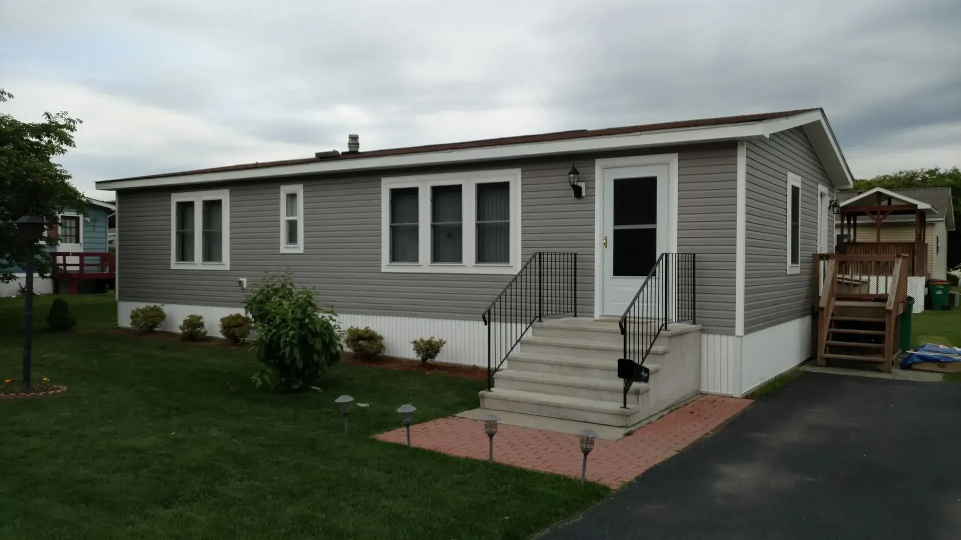 A mobile home with stairs leading up to the front door
