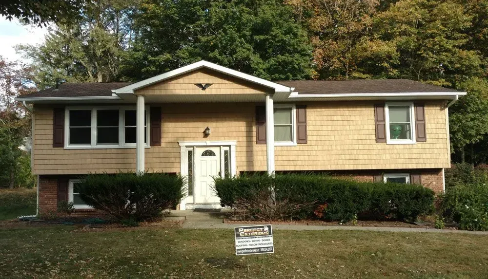 A house with a for sale sign in front of it