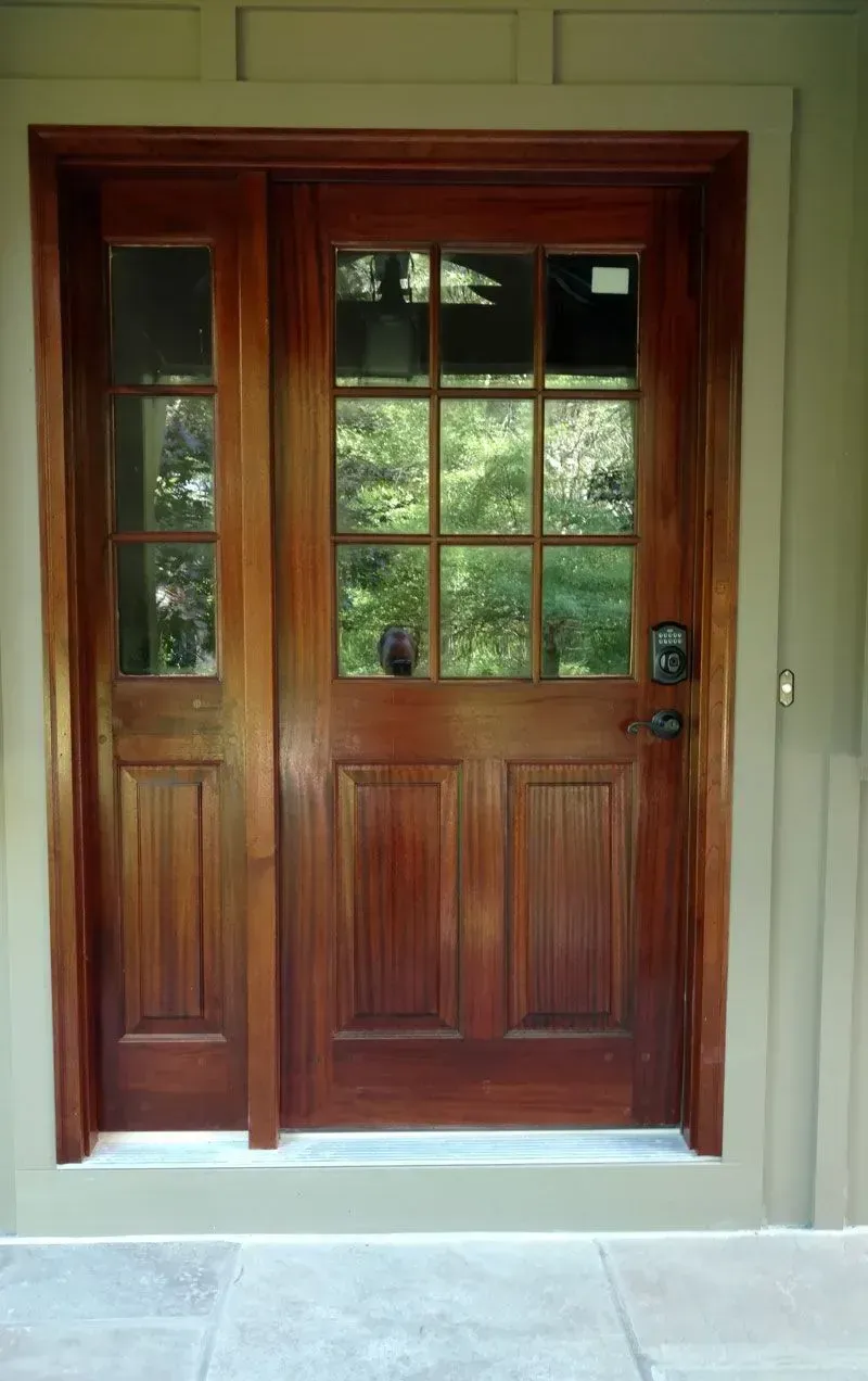 A large wooden door with a lot of windows