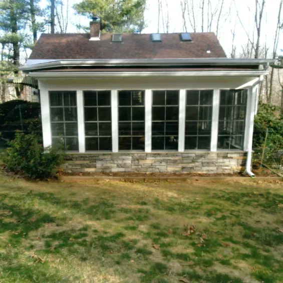 A house with a lot of windows and a brown roof