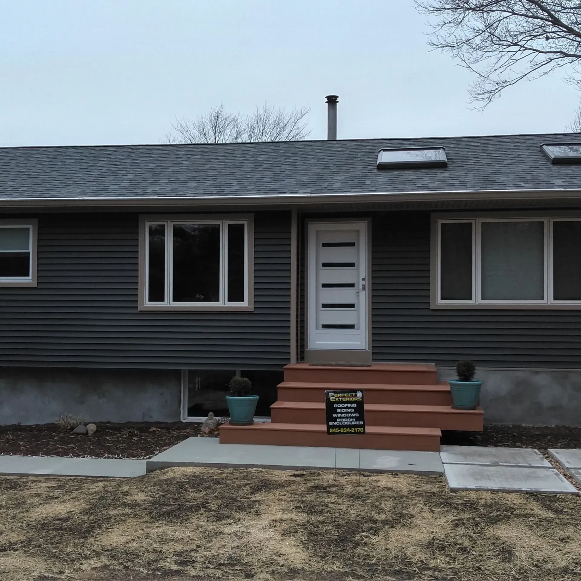 A house with a sign in front of it that says ' for sale '