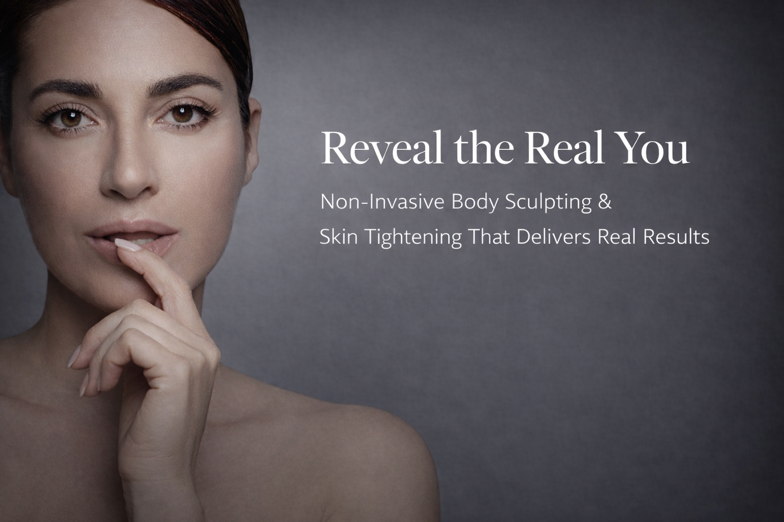 A woman with curly hair is smiling and holding her hands to her face.