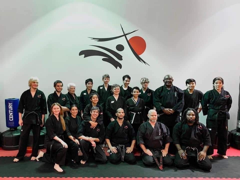 a group of people are posing for a picture in a gym .