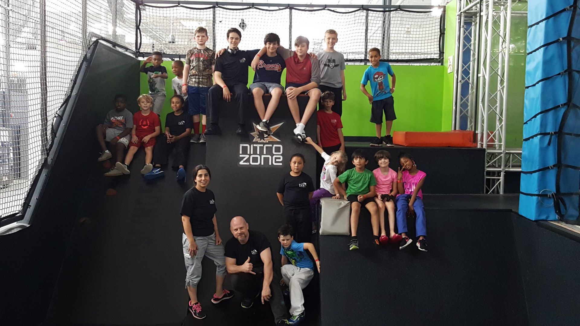 a group of children are posing for a picture on a trampoline .
