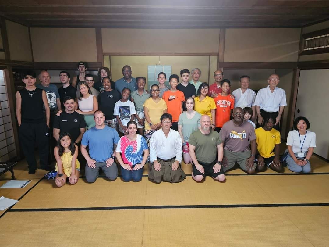 a group of people posing for a picture with one man wearing a shirt that says jeep
