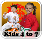a boy and a girl are standing next to each other in karate uniforms .