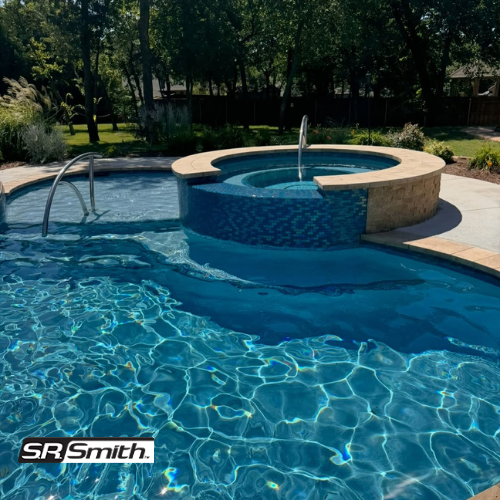 Pool with attached spa, blue water, stone accents, stainless steel handrails, sunny outdoor setting — NQ Pool Supplies in Smithfield, QLD