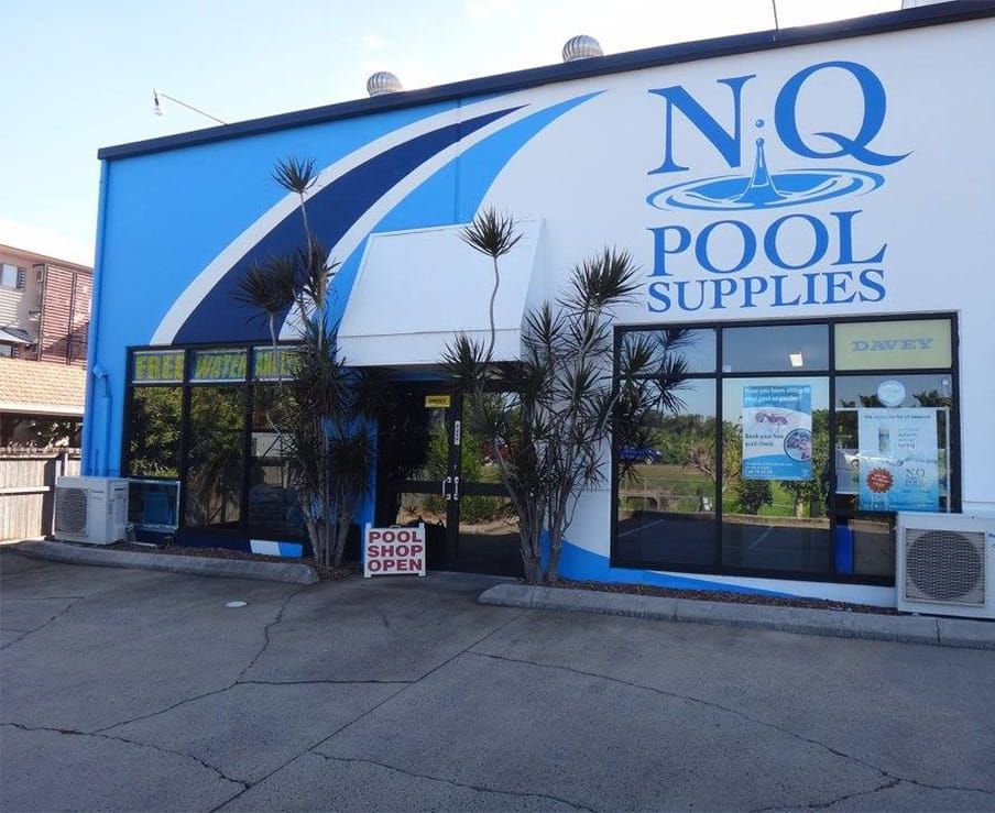 Exterior of NQ Pool Supplies store with blue and white branding, including a sign that says 