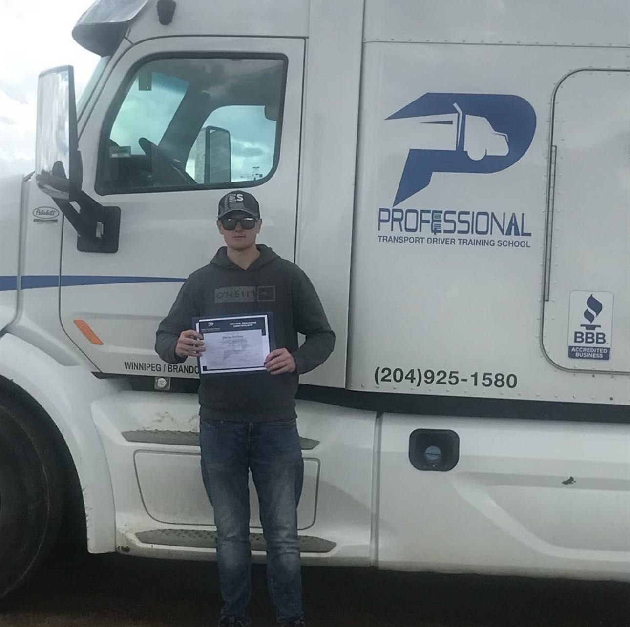 A man standing in front of a professional truck