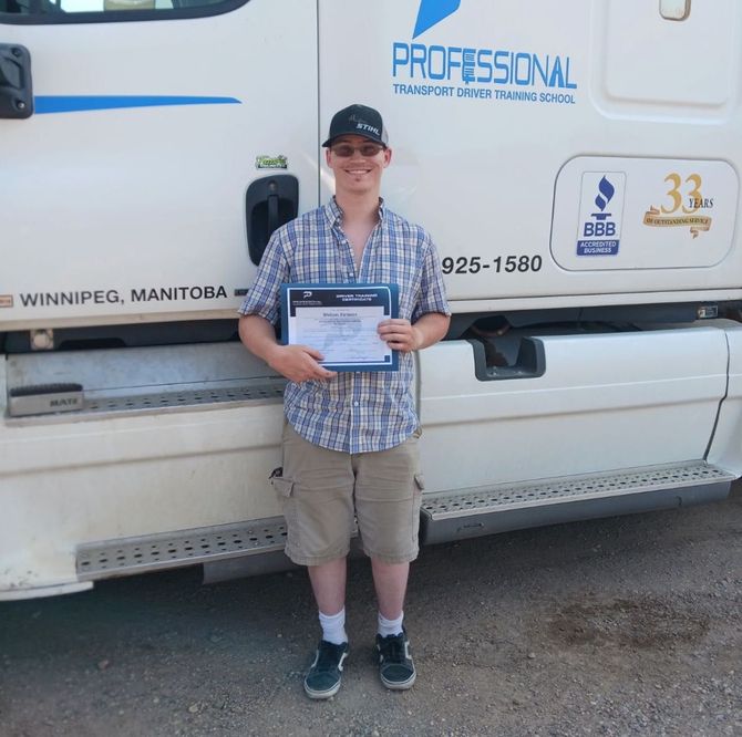 A man is standing in front of a professional truck