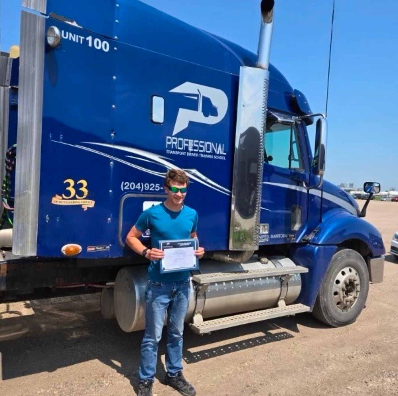 A man standing in front of a blue truck that says professional