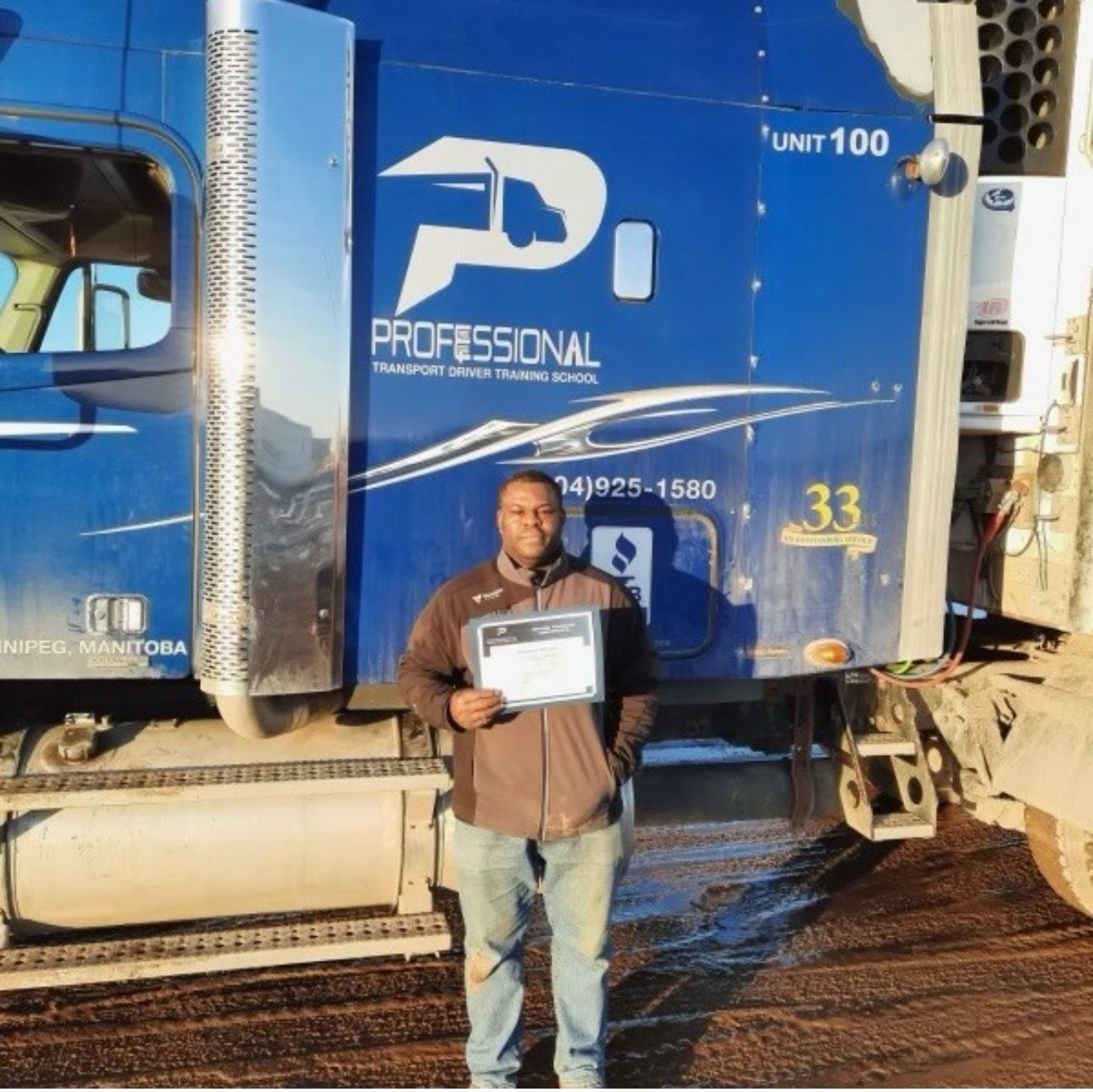 A man standing in front of a blue professional truck