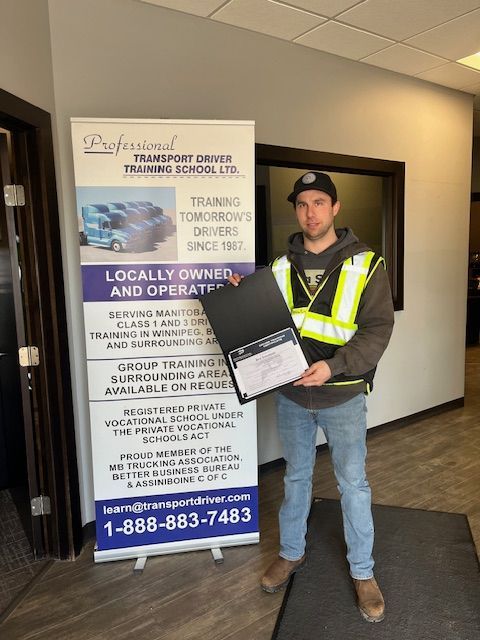 A man standing in front of a sign that says locally owned and operated