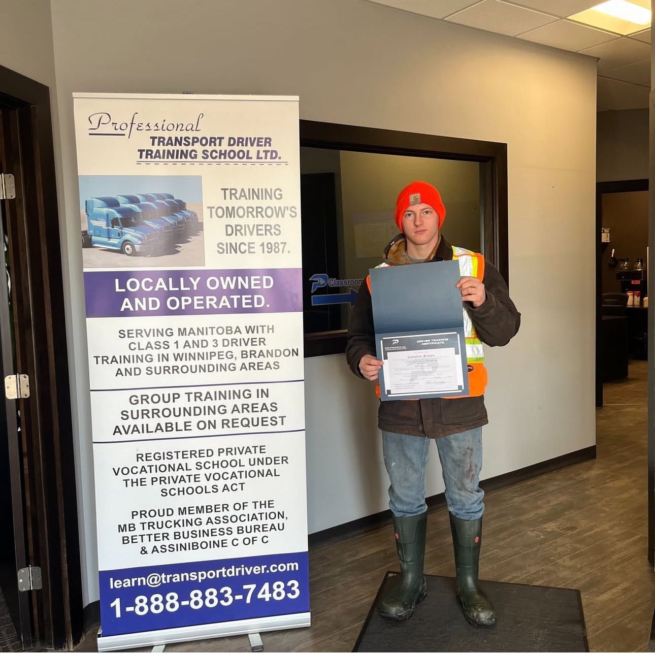 A man standing in front of a sign that says locally owned and operated