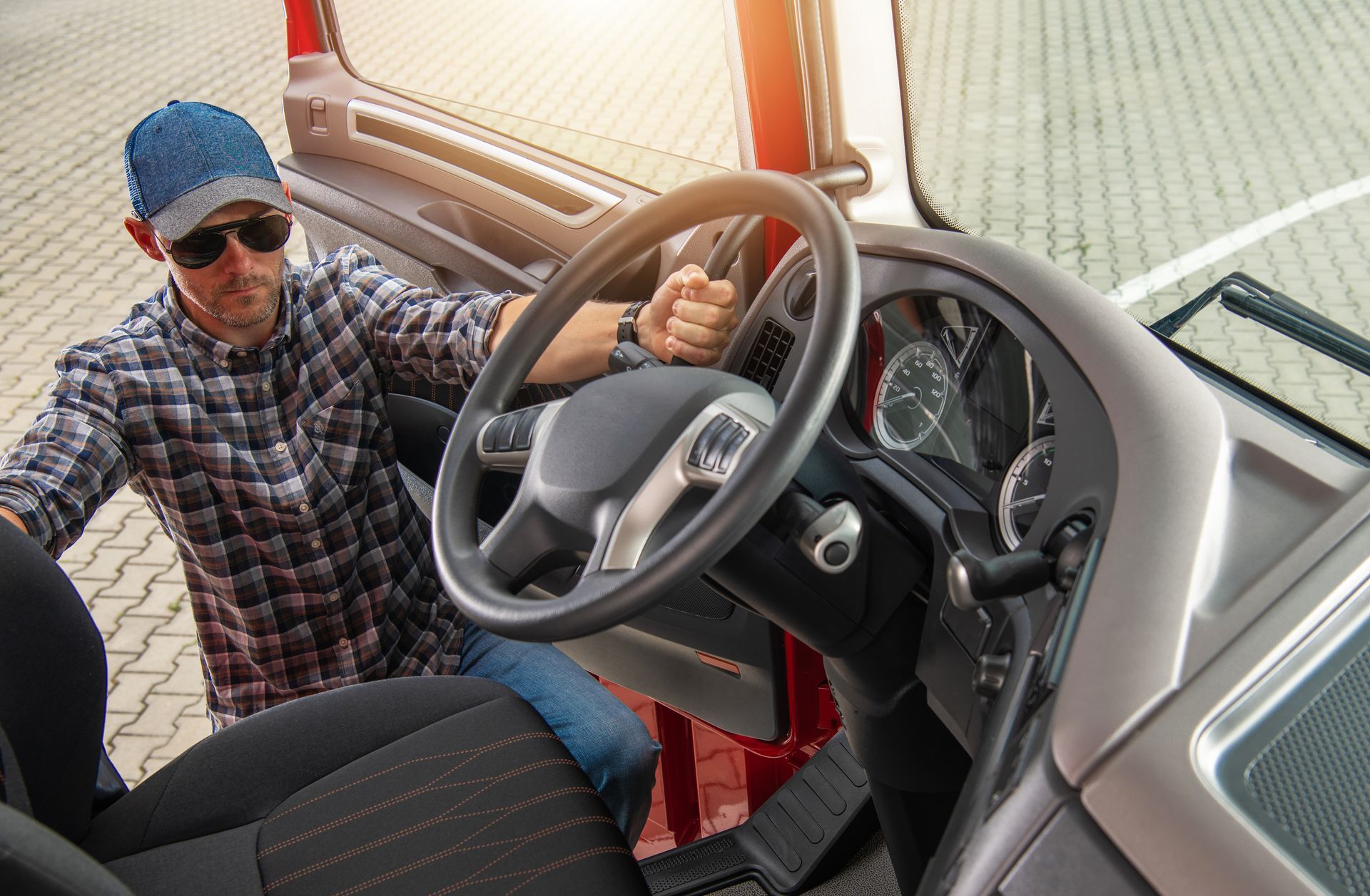a man is getting in the driver 's seat of a truck .