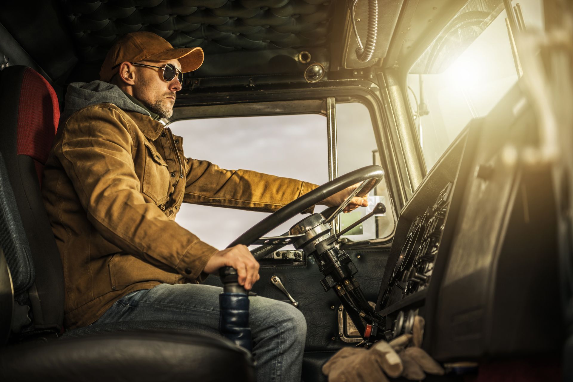 a man is sitting in the driver 's seat of a semi truck .