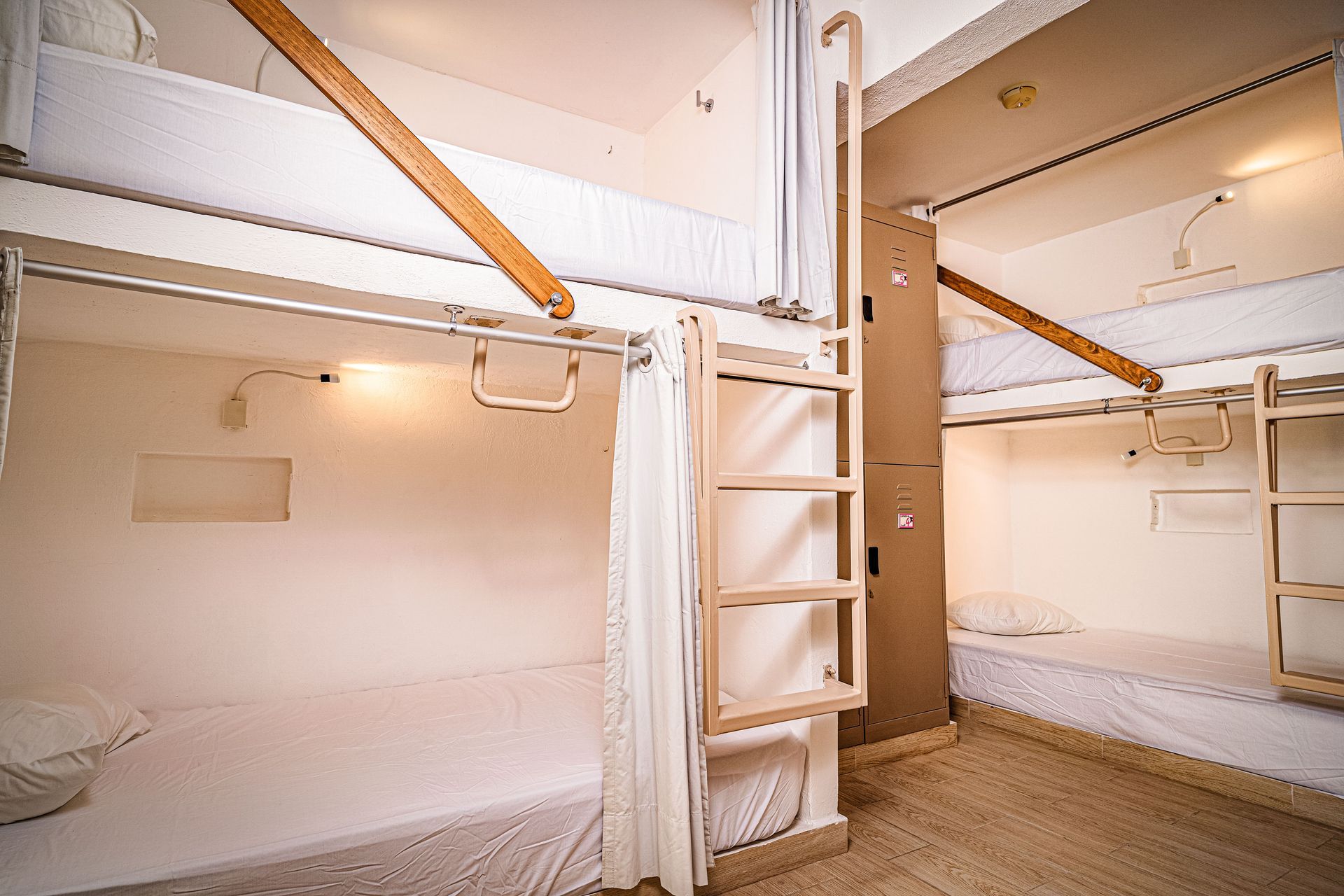 A room with bunk beds and a ladder in it.