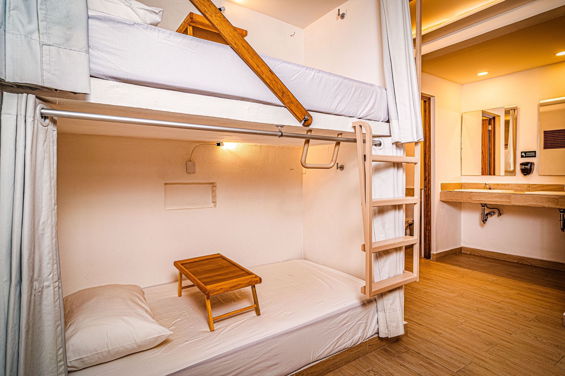 A bunk bed with a table underneath it in a room.