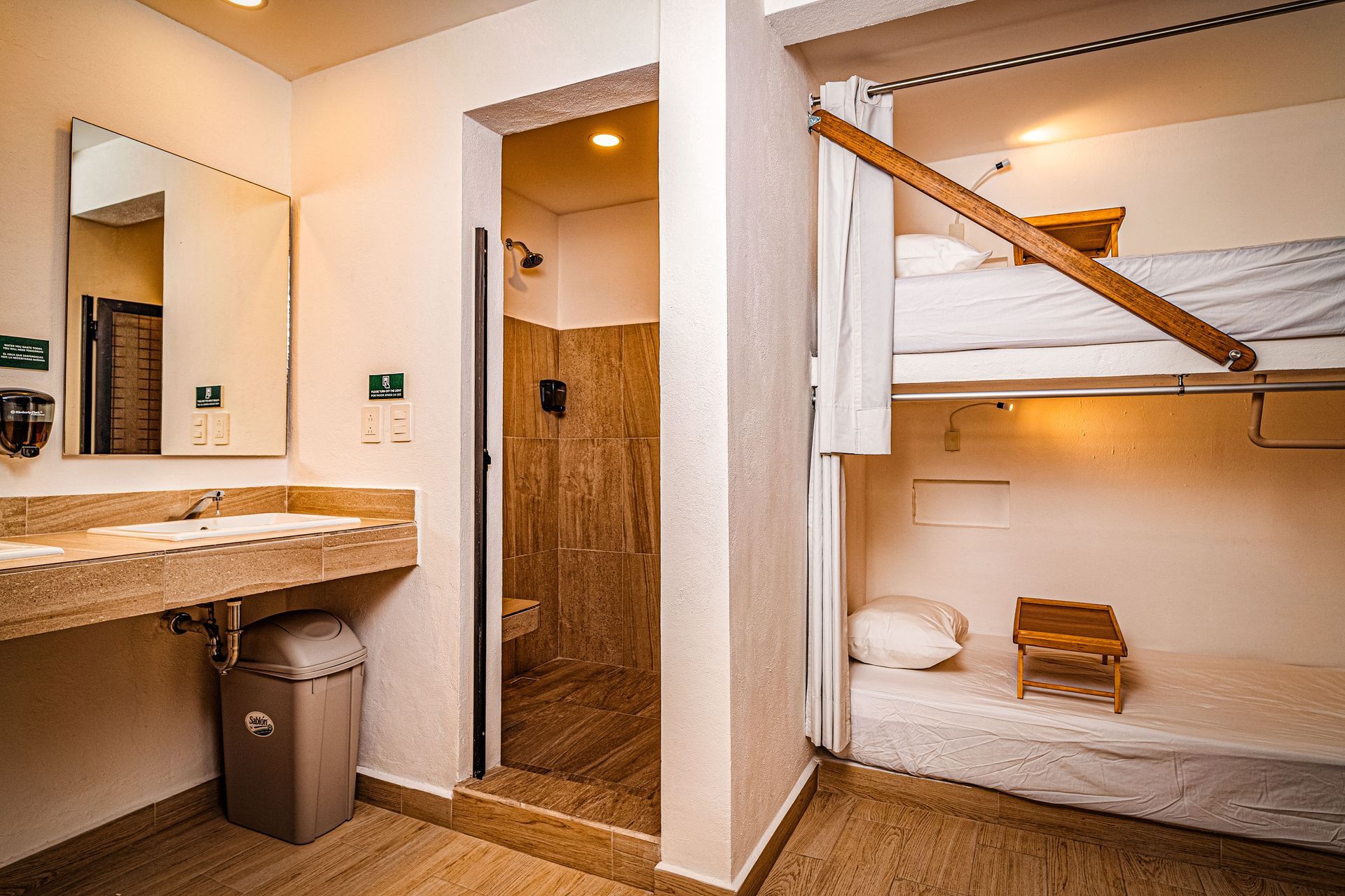 A bathroom with a bunk bed and a sink.