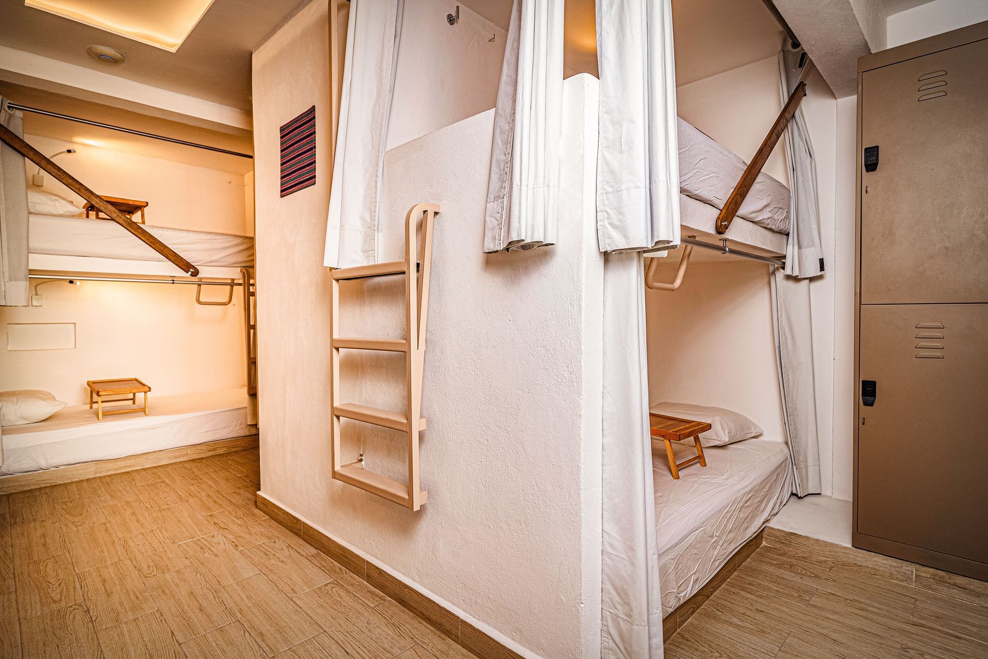 A room with bunk beds and a ladder in it.