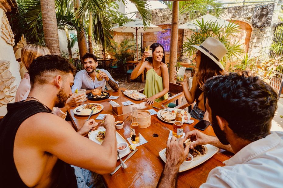 A group of people are sitting at a table eating food.