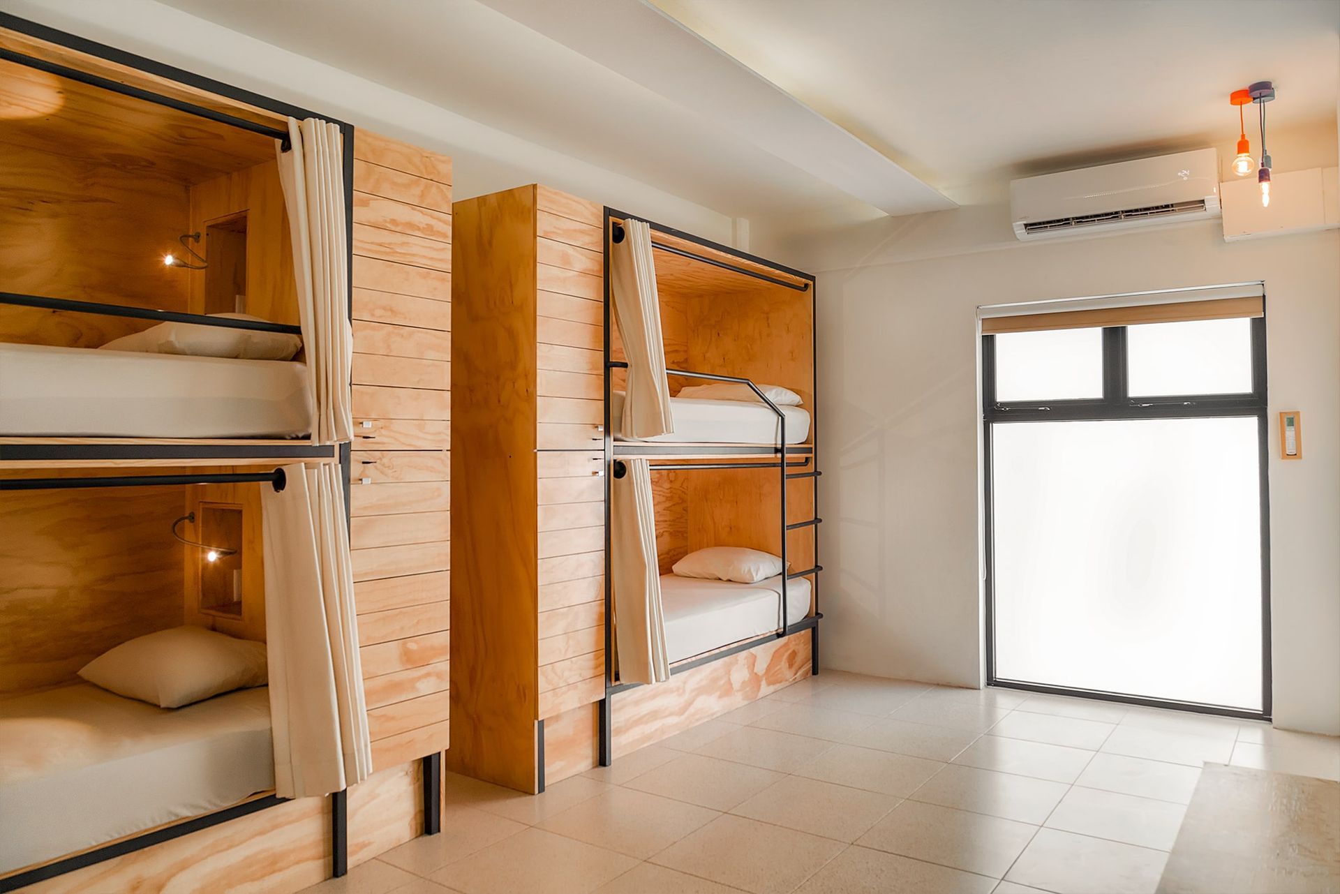 A room with bunk beds in it and a window.