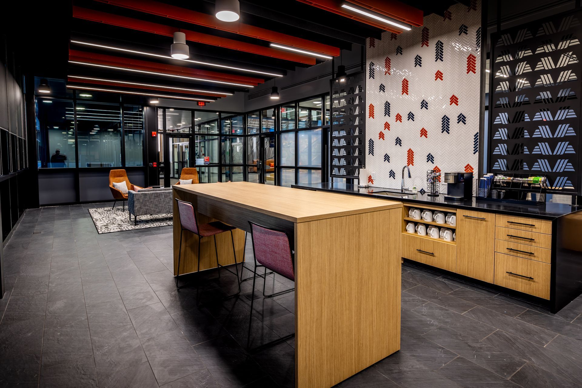 Reception desk with colorful art backdrop and leather armchairs.