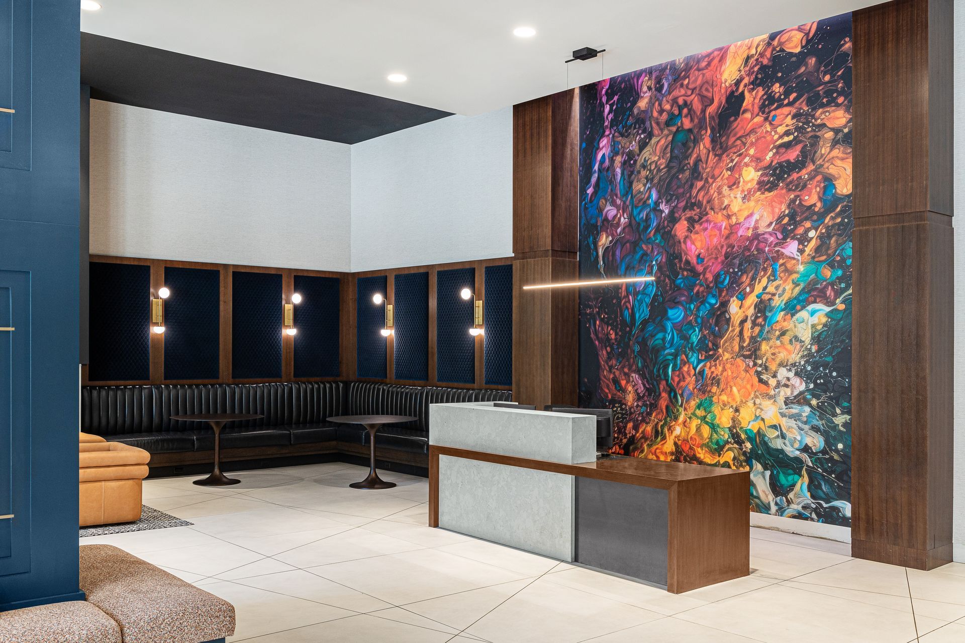 Lobby with abstract art on the wall, a reception desk, and seating.