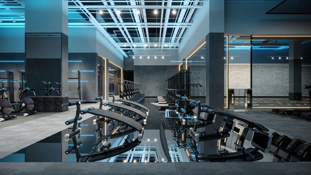 Modern gym interior with exercise equipment and reflective floor. Blue and gray color scheme.