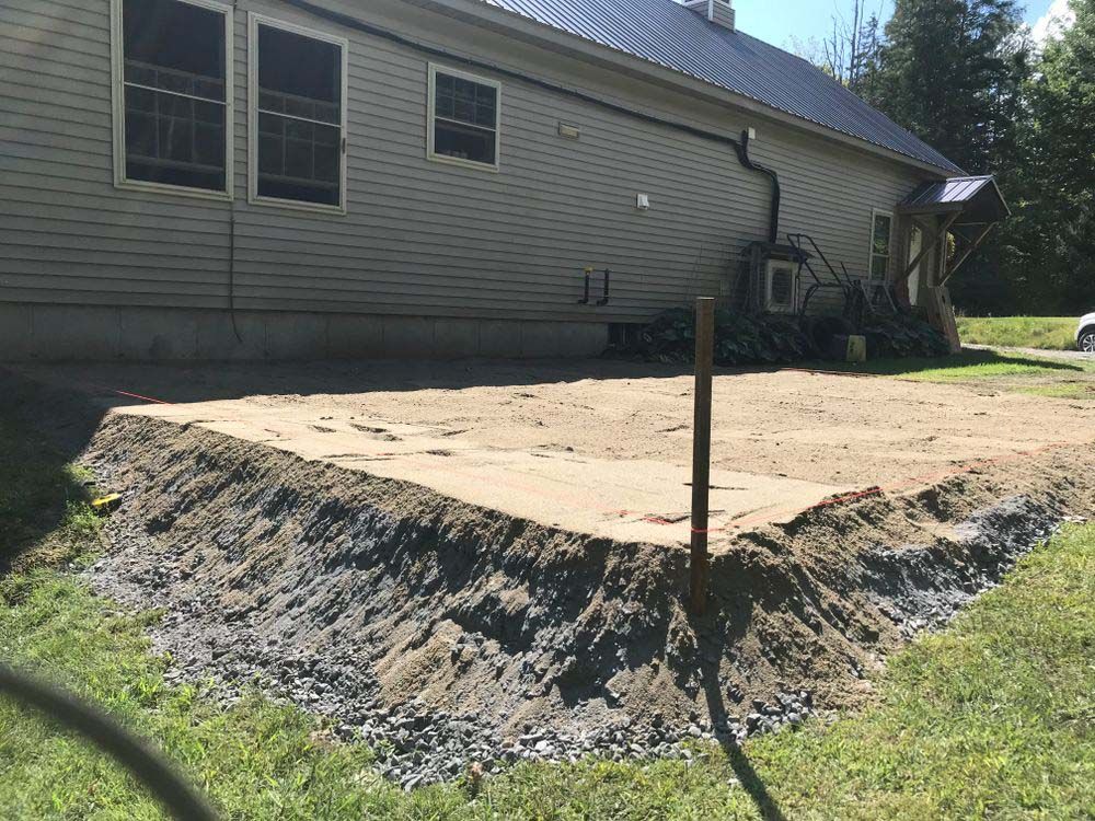 A house with a lot of dirt in front of it.