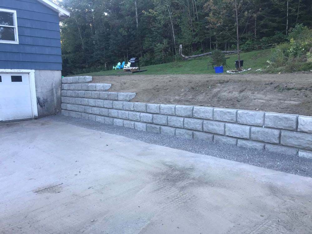 A concrete wall is being built in front of a house.