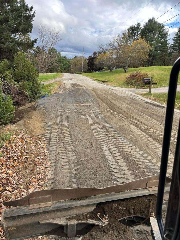 A bulldozer is moving dirt on a dirt road.