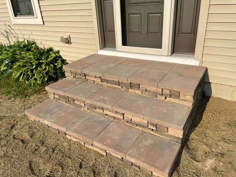 A set of steps leading up to the front door of a house.
