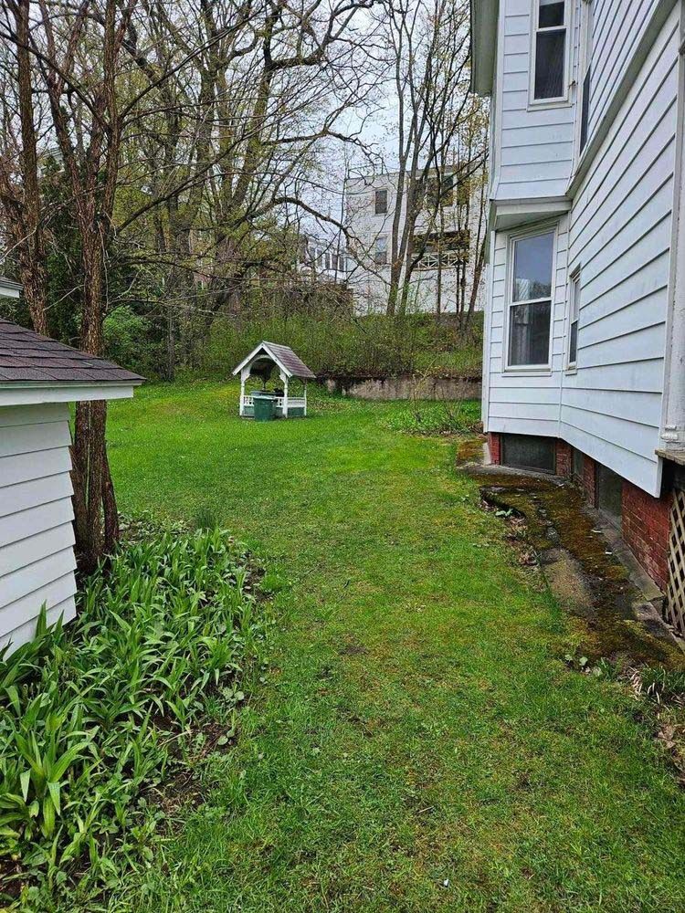 There is a well in the backyard of a house.